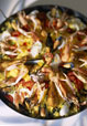 Paella aux langoustines et cuisses de poulet